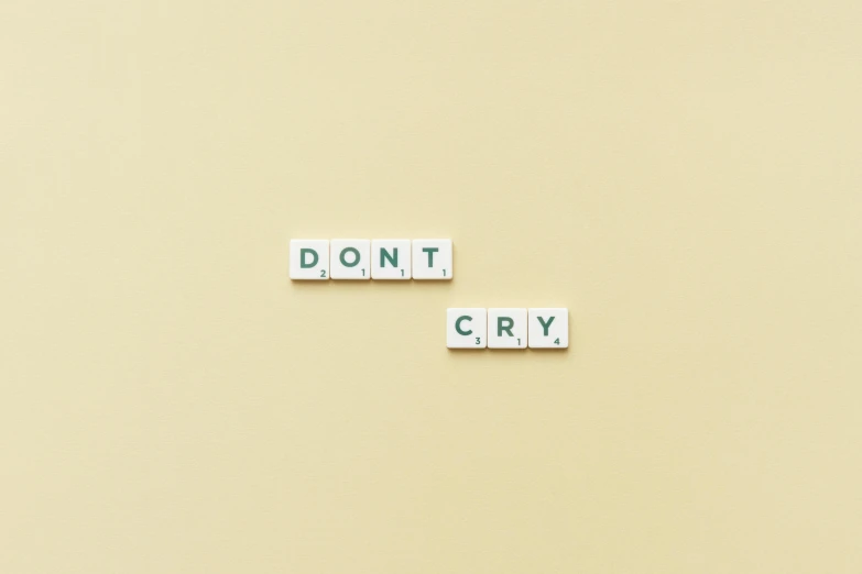 scrabble type letters are arranged into the words dont cry