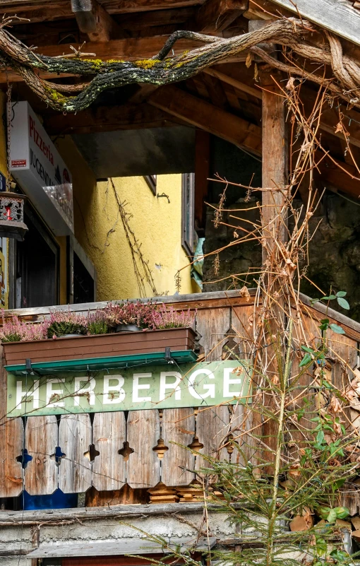 a wooden sign is posted on the side of a building