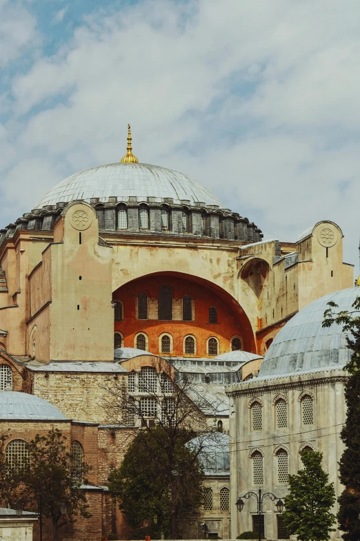 this old building has an orange dome and a gold and white roof