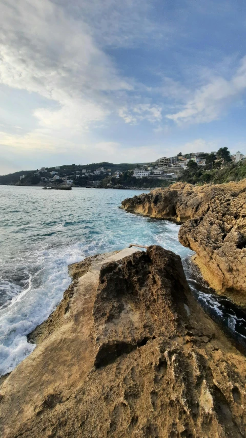 a beach filled with lots of rock next to the ocean