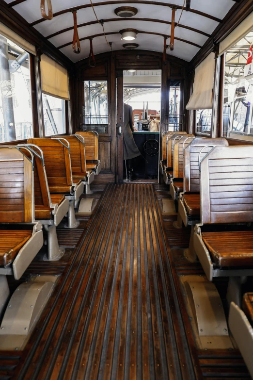 a train car that has wooden seats on the inside