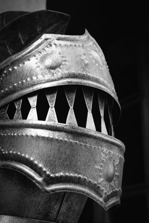 a black and white image of an old, rusty helmet