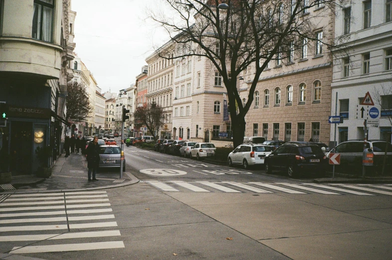 some buildings and a man crossing the street