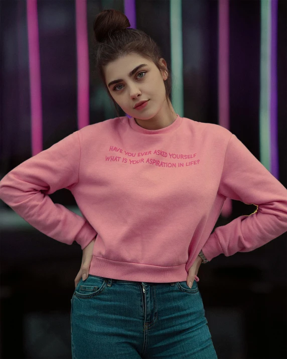 a young woman in pink sweatshirt with pink writing on it