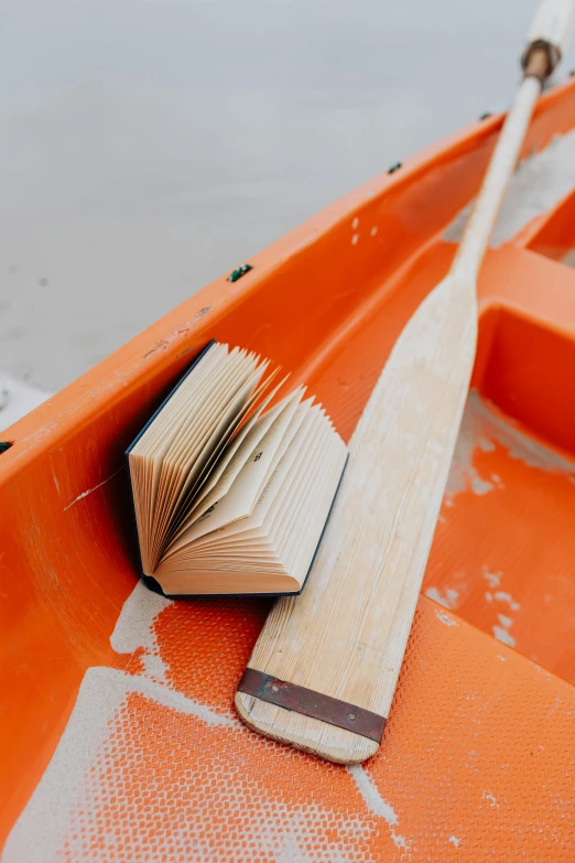 an old book sitting in the middle of a row boat