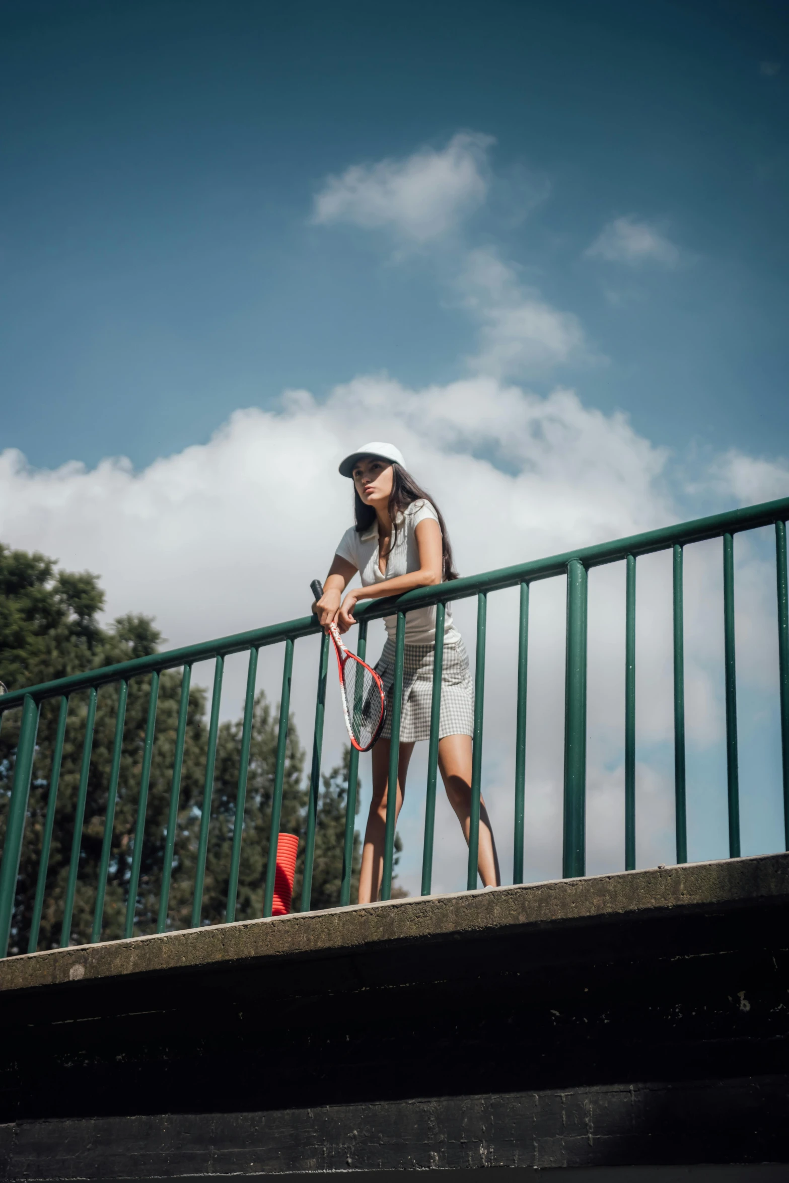 the woman is playing tennis against the fence