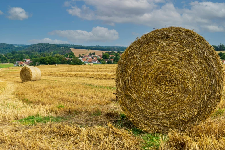 a hay bail is standing in a large field