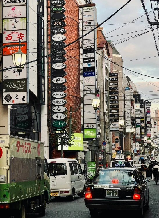 many traffic signs and a truck are on the road