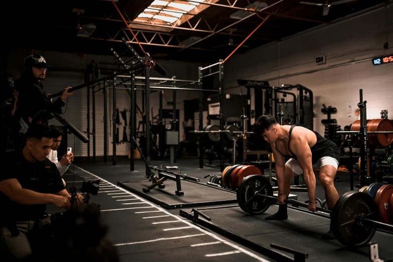 two men working on a barbell during a crossfit session