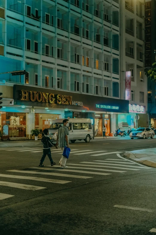 a man and woman crossing the street with shopping bags in their hands