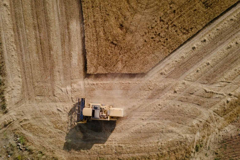 there is a truck working on some sand