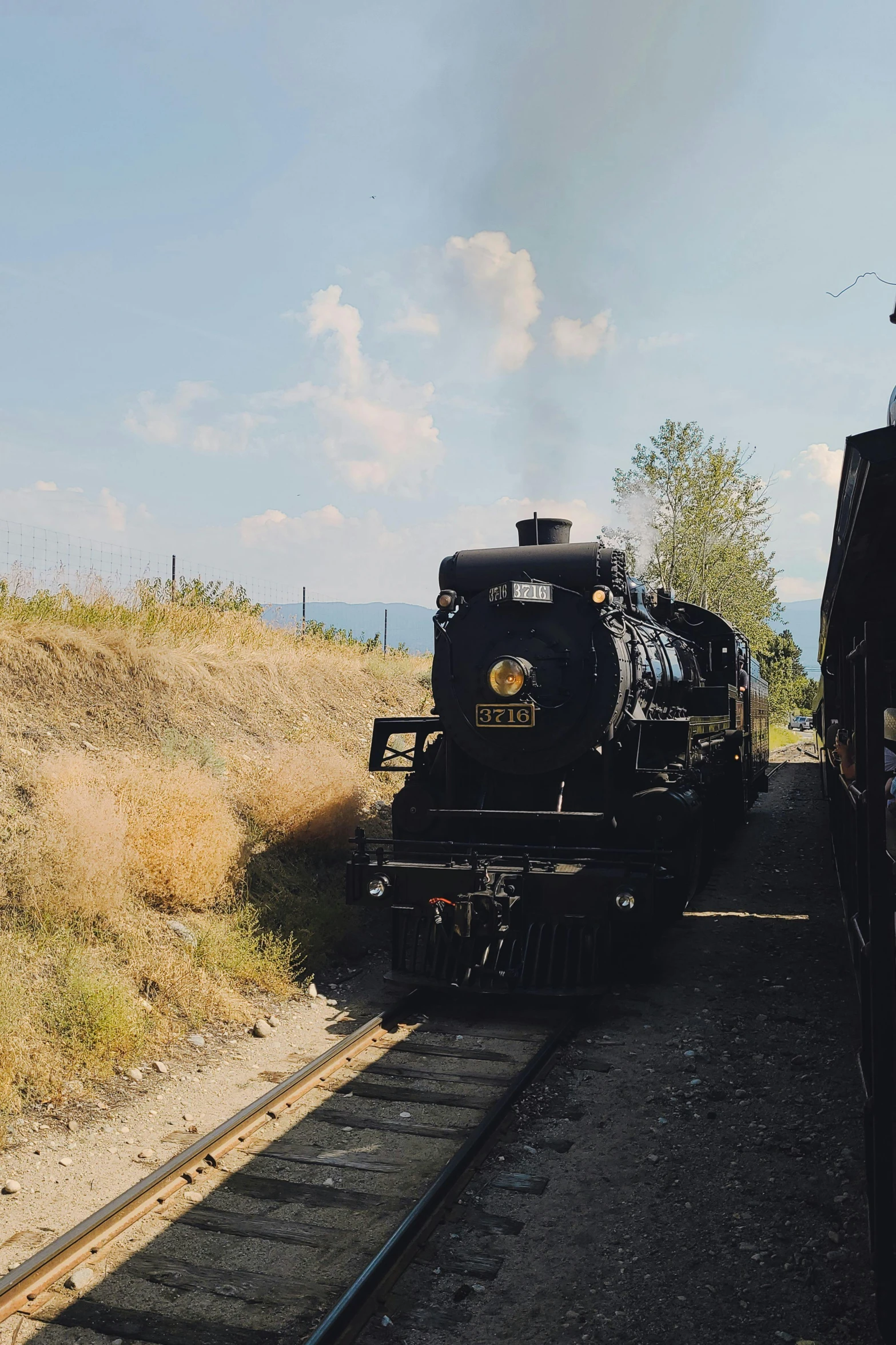 the train is pulling into the stop on the tracks