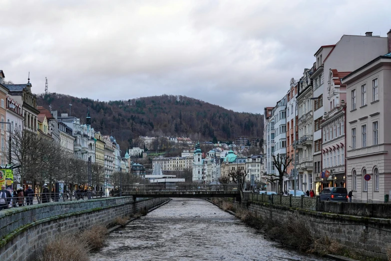 a river runs past old buildings in the town