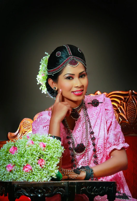 a woman wearing jewelry and sitting on a red couch