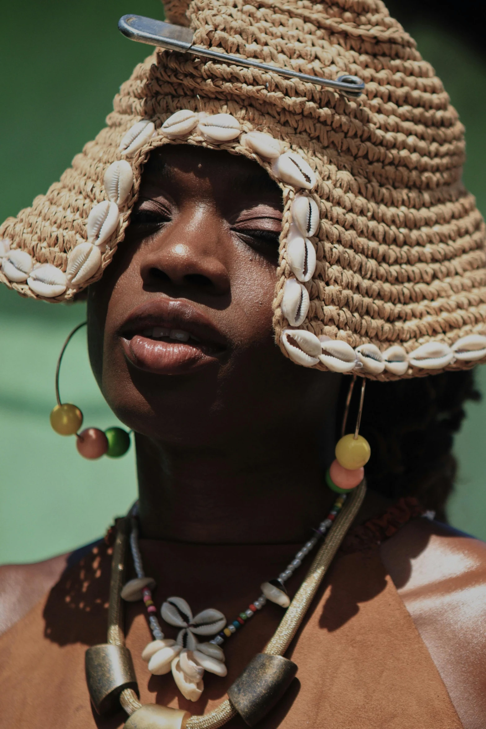 a woman wearing a hat with some beaded beads on it