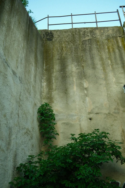 a skateboarder is leaning over on the edge of a wall