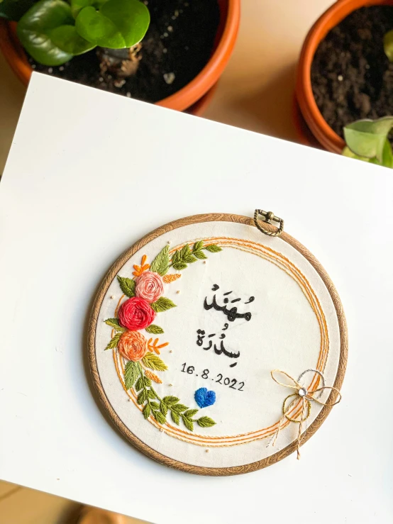 some very pretty embroidered designs on a white piece of paper