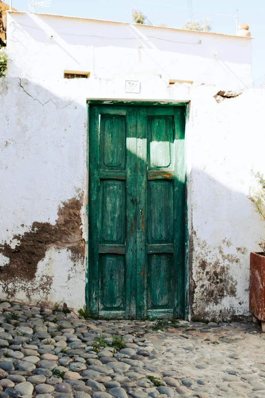 a bright green door of a white building