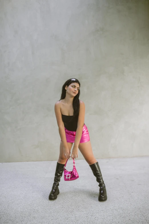 a young woman in pink shorts is posing