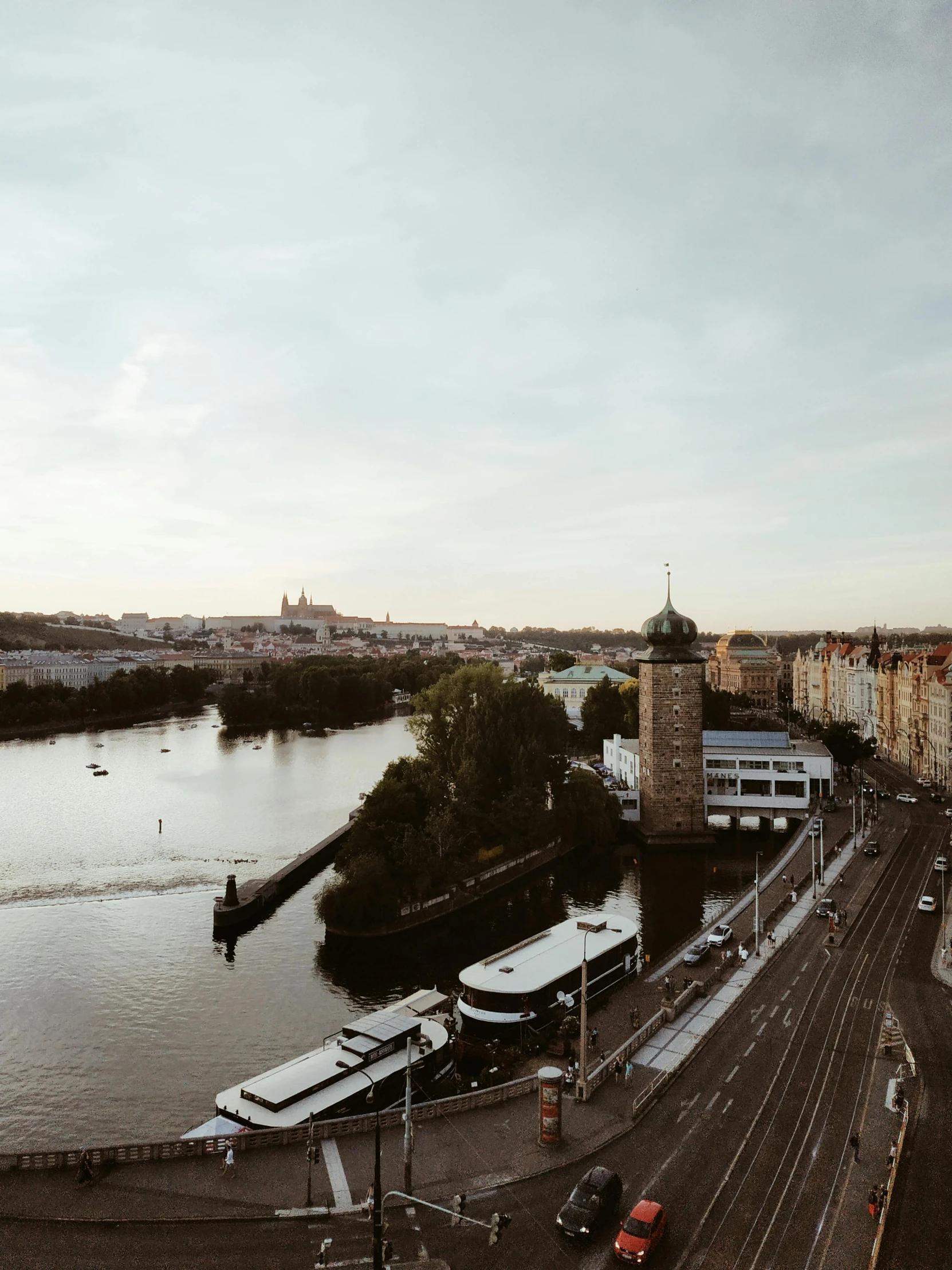 there is a large river with several buses parked on the side