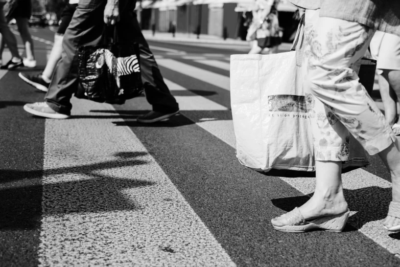 people are walking in the street with bags