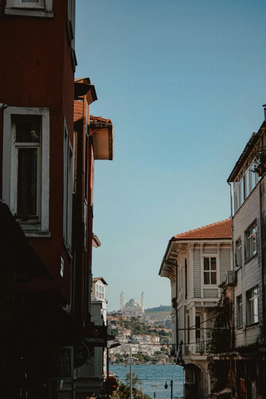 some houses along a river and buildings that are brown