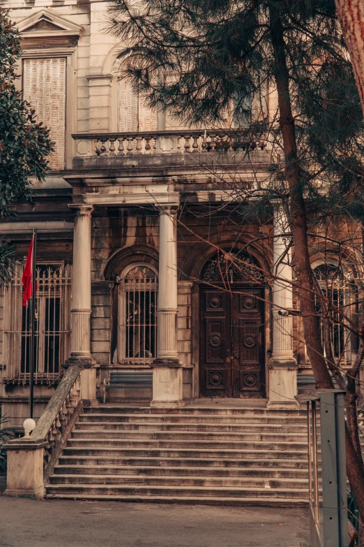 a big brown building with stairs and steps leading to it