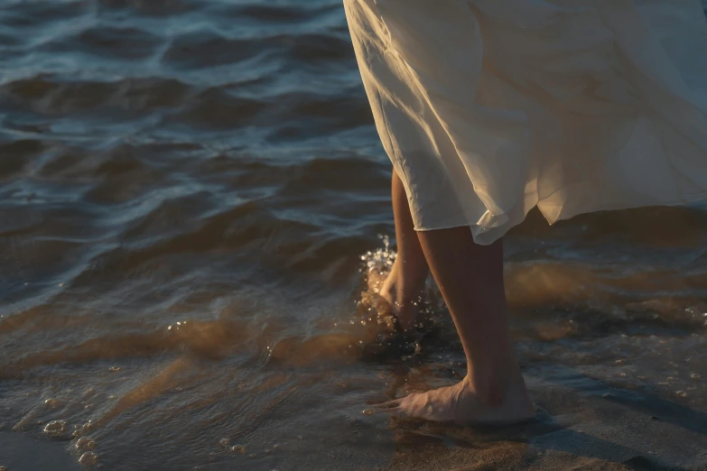 an image of the legs of a women in the water