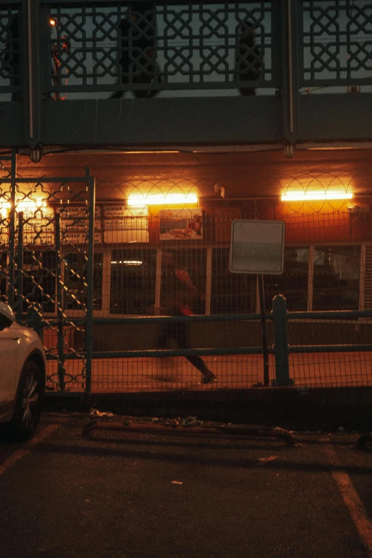 an illuminated store front with cars outside at night