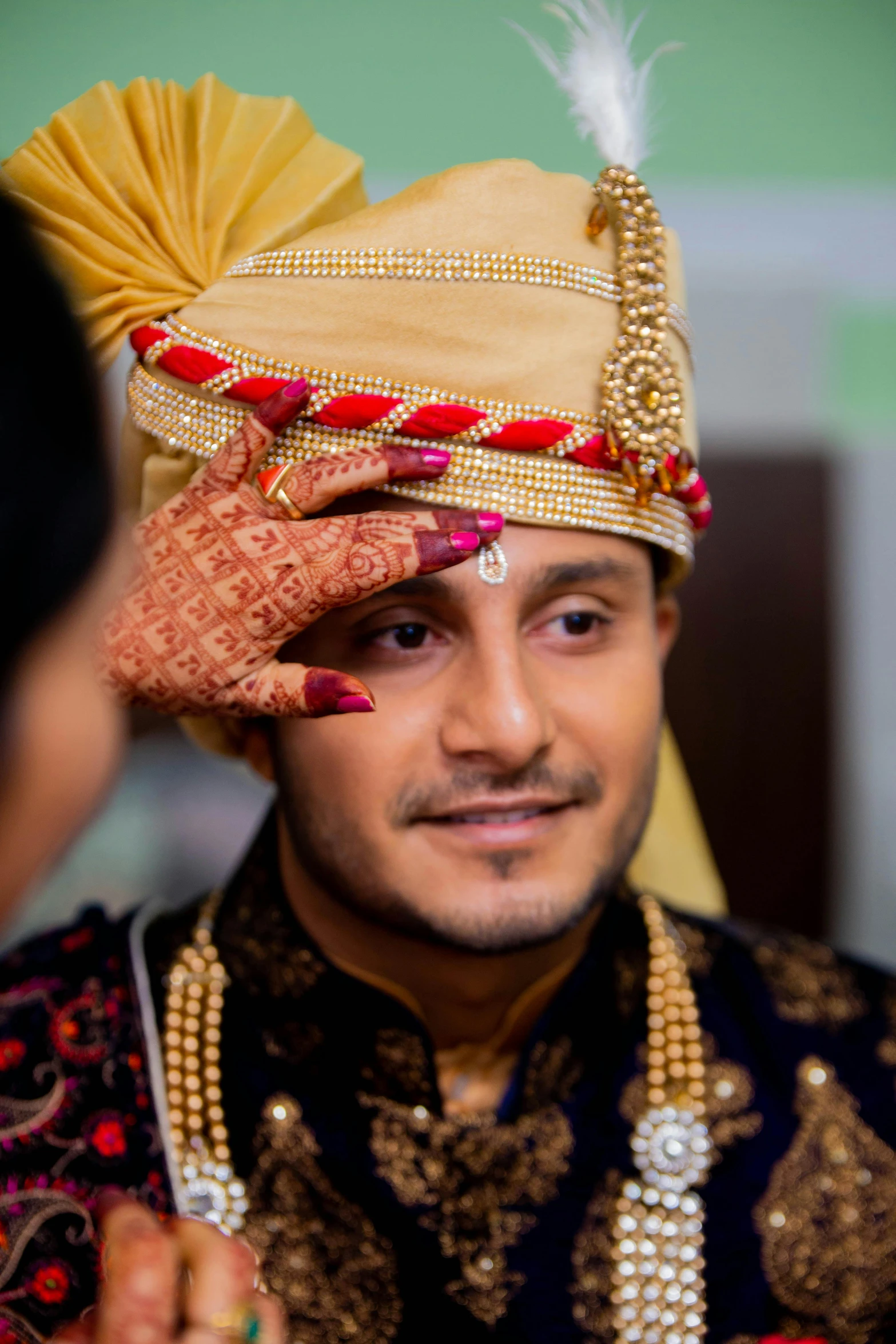 a man is putting on a hendi for his bride