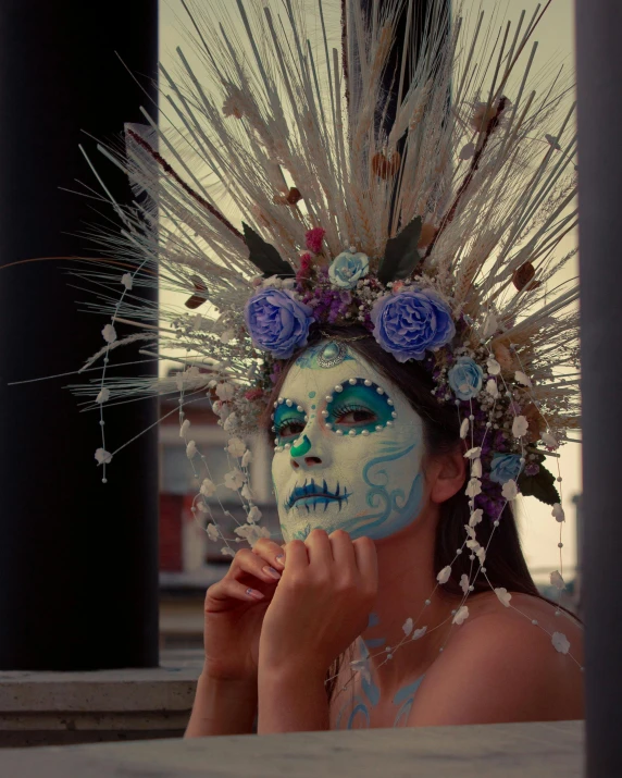 a woman is posing for a po wearing a mask and flowers