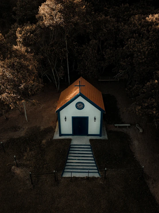 small chapel at the top of a mountain in the woods