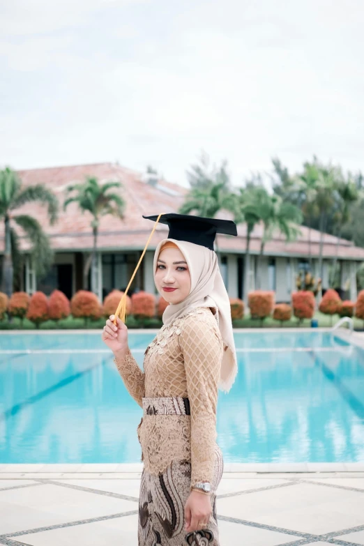 a woman wearing a graduation gown and hat