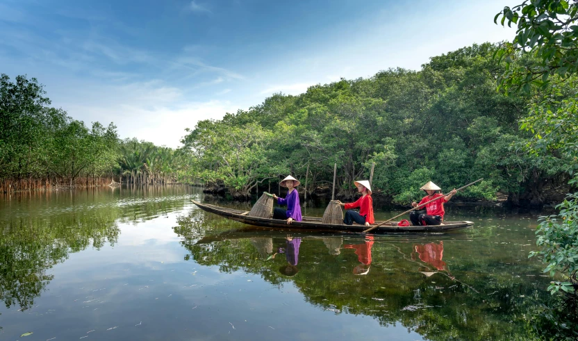 three people in a canoe on the water