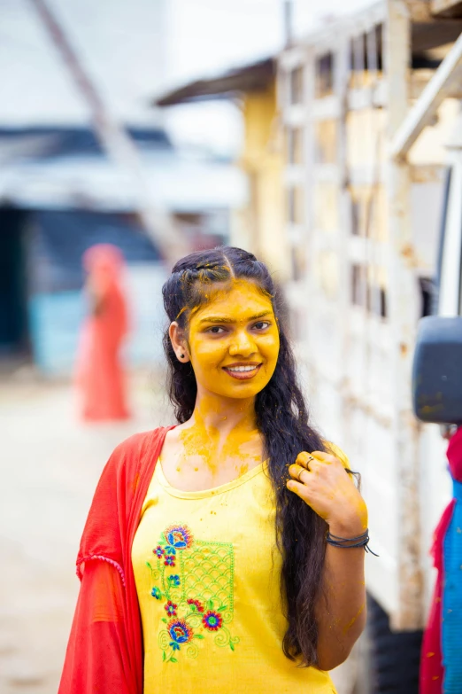 the girl is covered in yellow paint posing