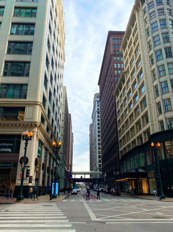 people are walking on a city street in a wide city