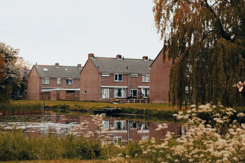 a row of buildings in a city near a pond
