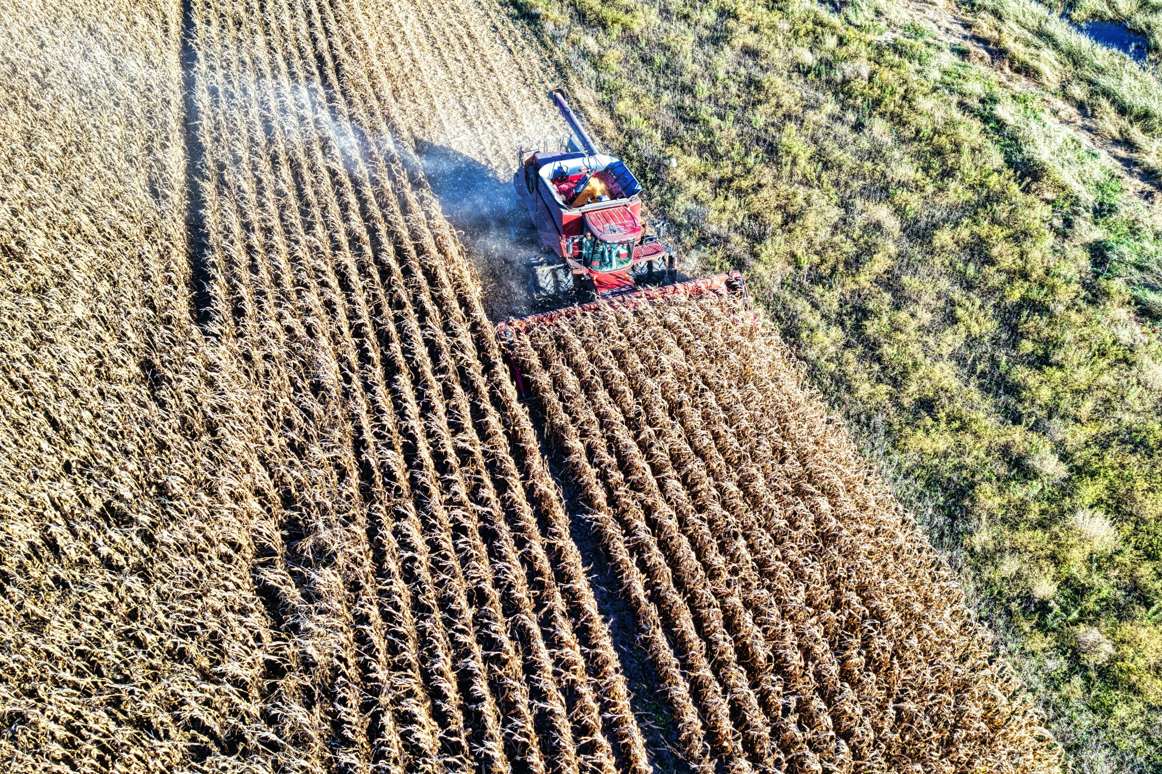 the tractor and a truck are driving through an open field