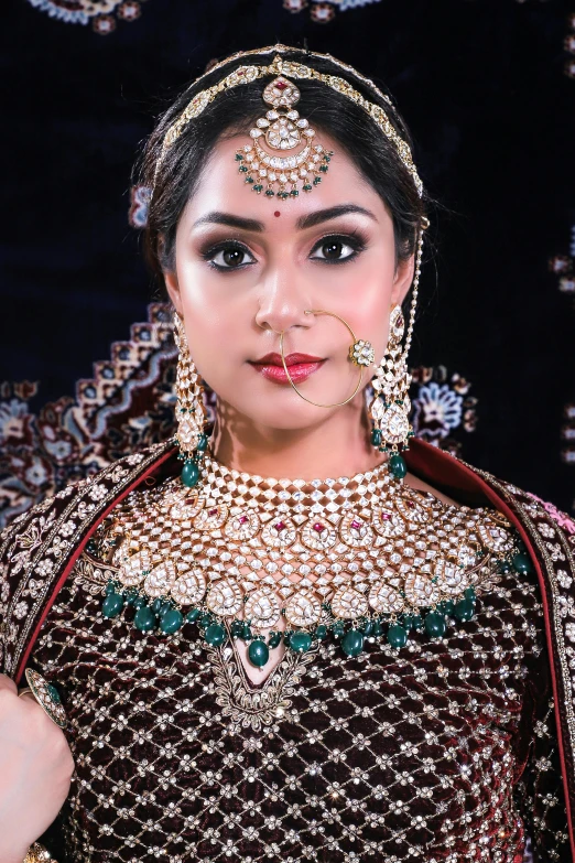 beautiful young indian model with jewelry in her hand