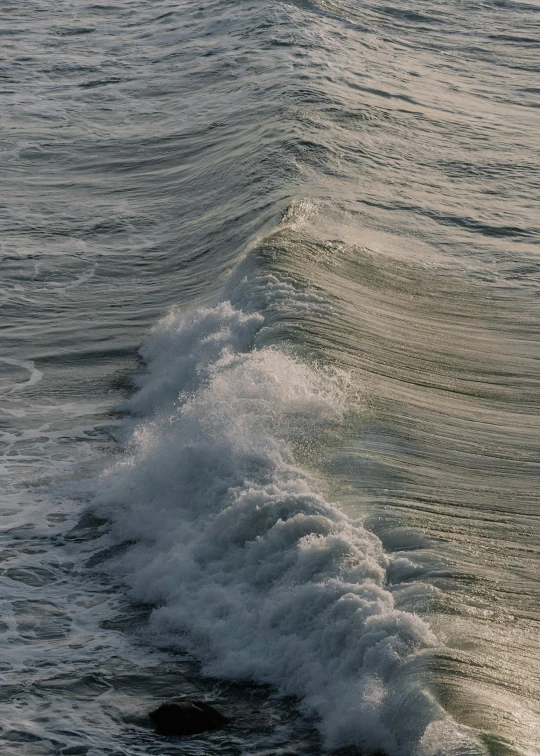 large white waves crashing on top of a calm ocean