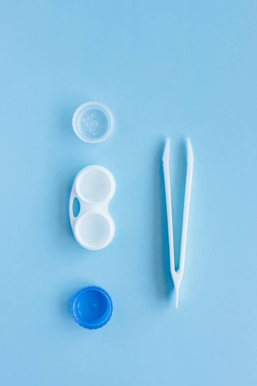 a blue table with various plastic tools for making toothbrushes