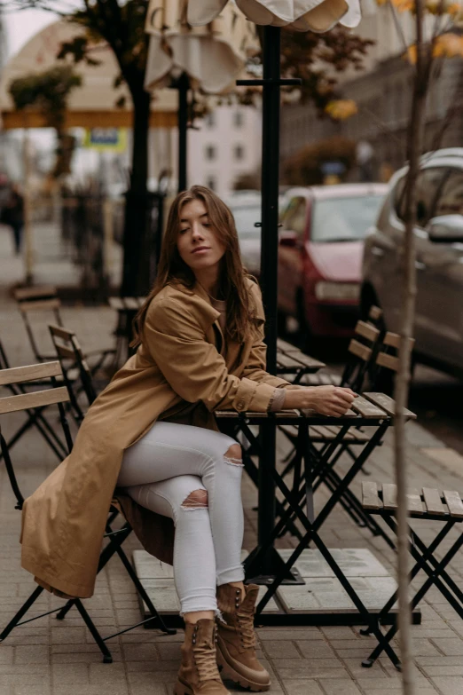 a woman sitting at an outdoor cafe