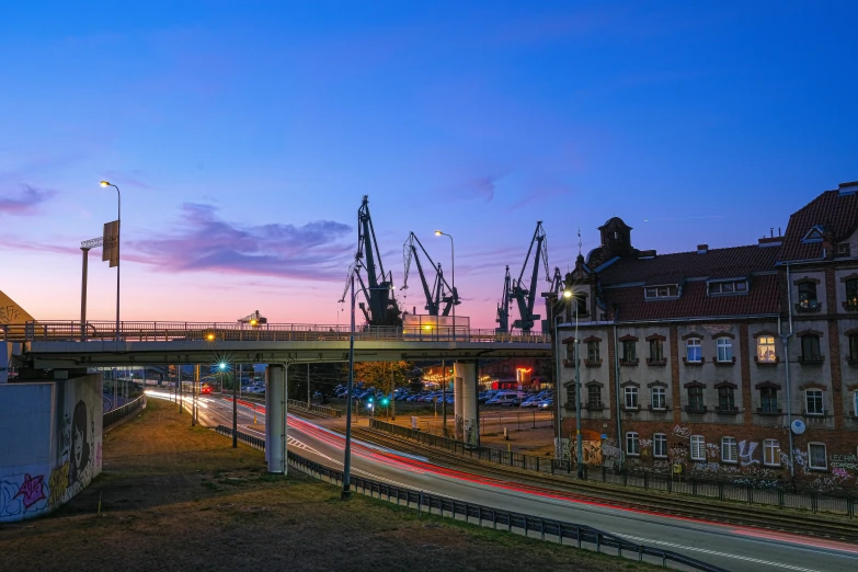 a cityscape with boats and a dock at dusk