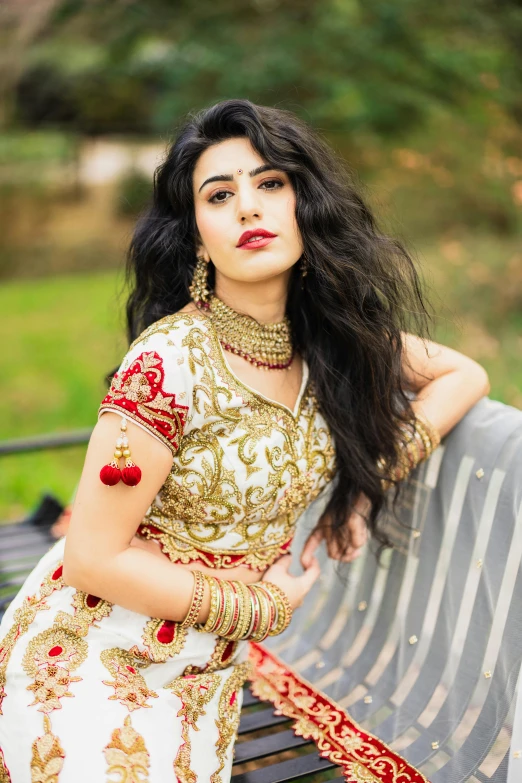 a woman in a dress on a bench in the park