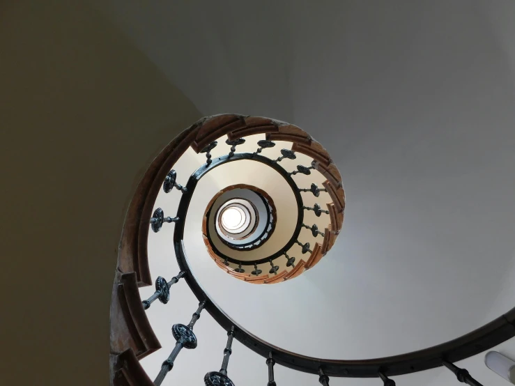 this is an upward view of the spiral staircase