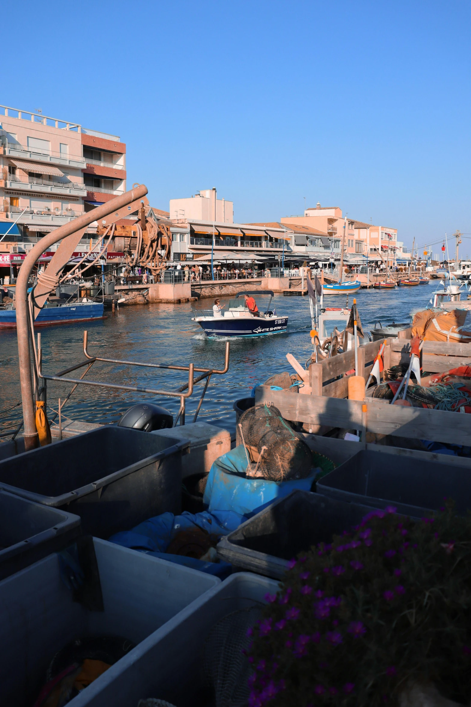 a harbor with boats, some on boats and houses