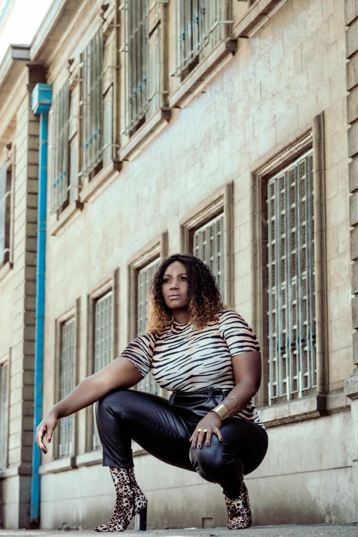 the woman is posing by the building posing