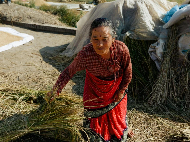 the woman is holding grass in her hand