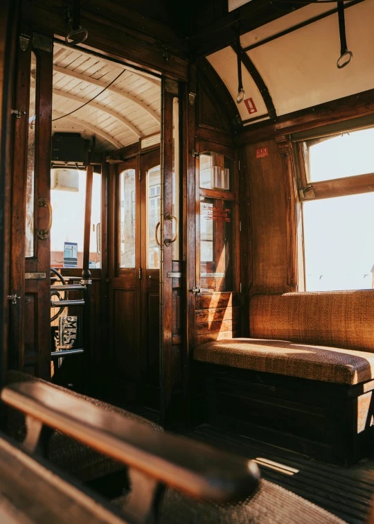 the inside of a cabin train with two benches and some windows