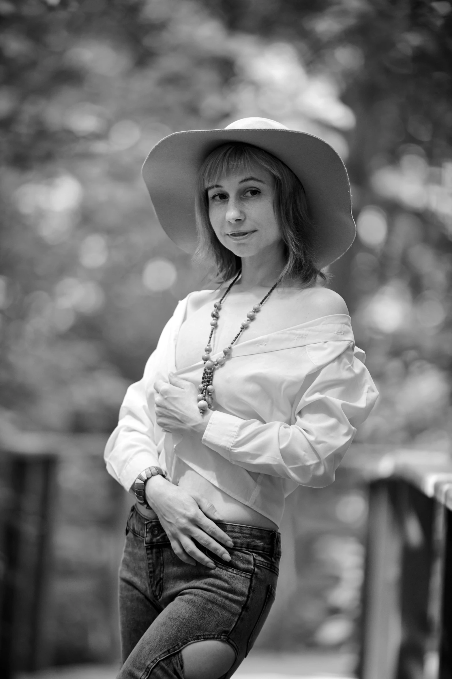 a woman wearing a hat is posing for a black and white po